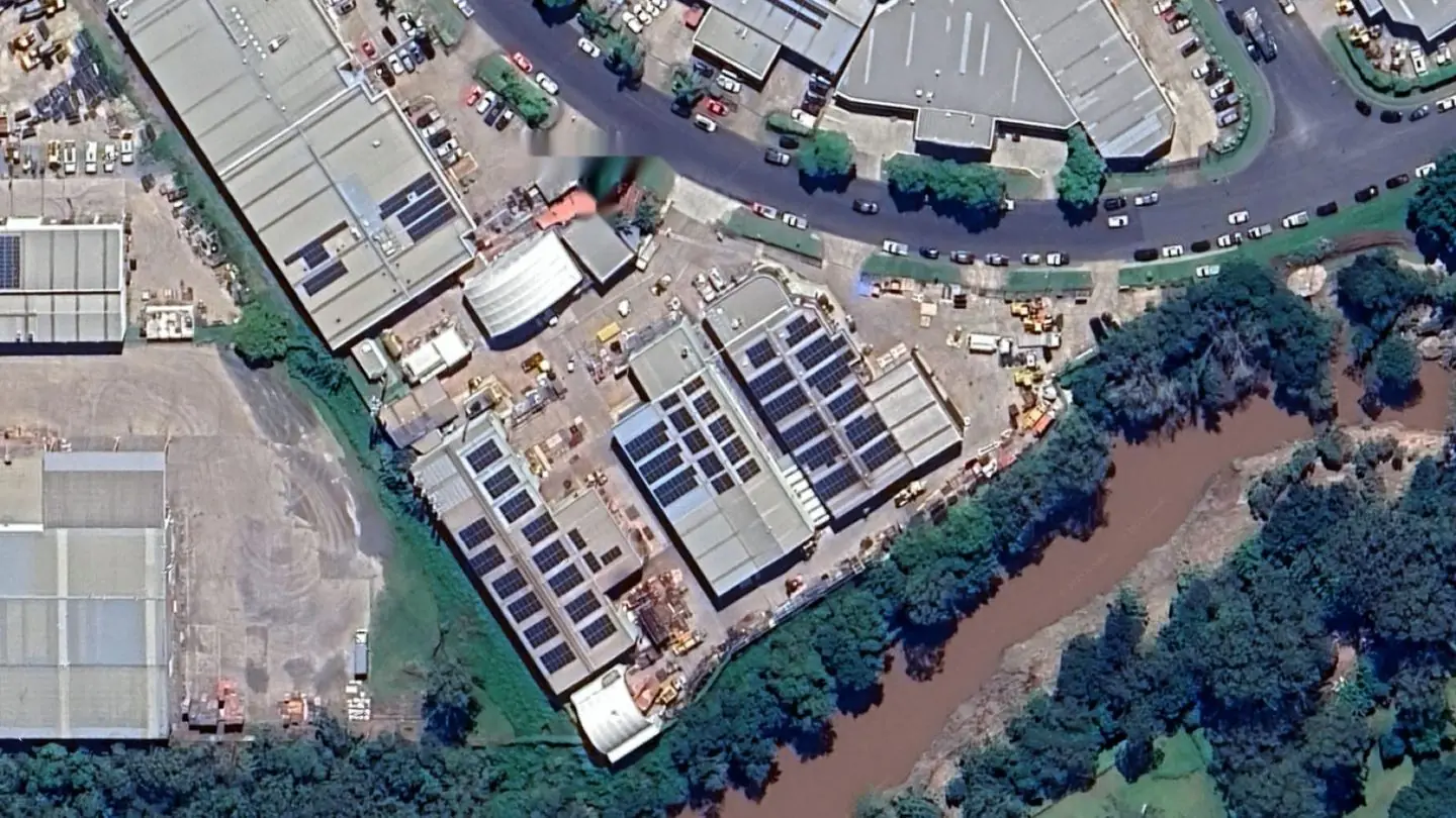 Aerial view of 53 Success Street in 2025: workshops built out to the site boundaries with solar panels across the roofs