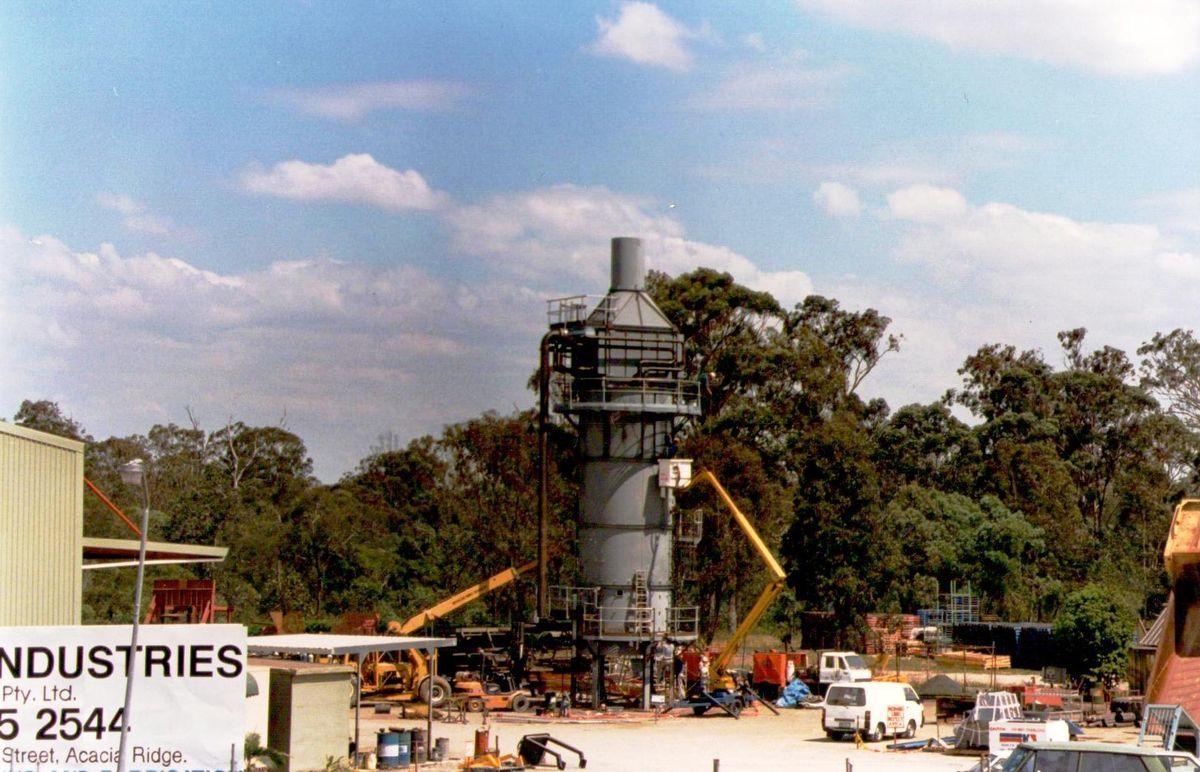A fabricated boiler and exhaust stack standing beside the Success Street sign