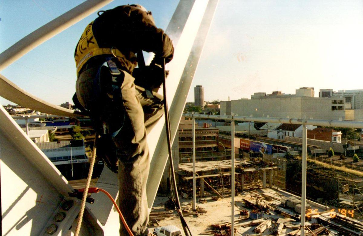 A QMW welder working aloft on structural roof steel