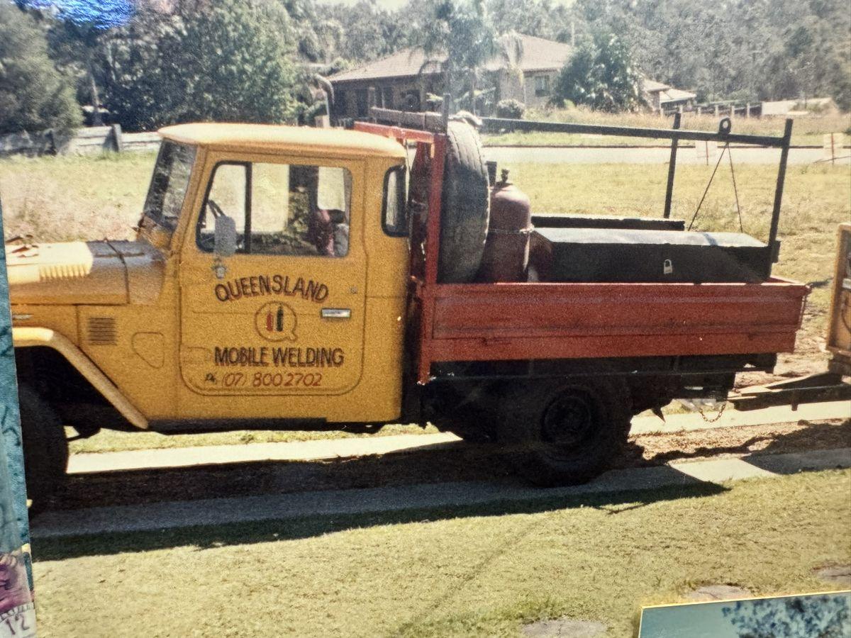 Yellow Queensland Mobile Welding tray-back ute carrying a welder and gas bottles