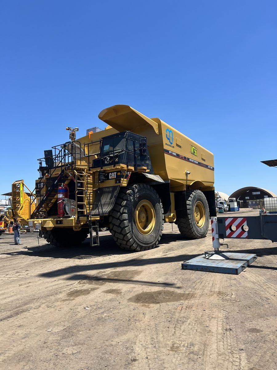 A Cat 785 haul truck fitted with a QMW WT-110 water tank at a Blackwater mine