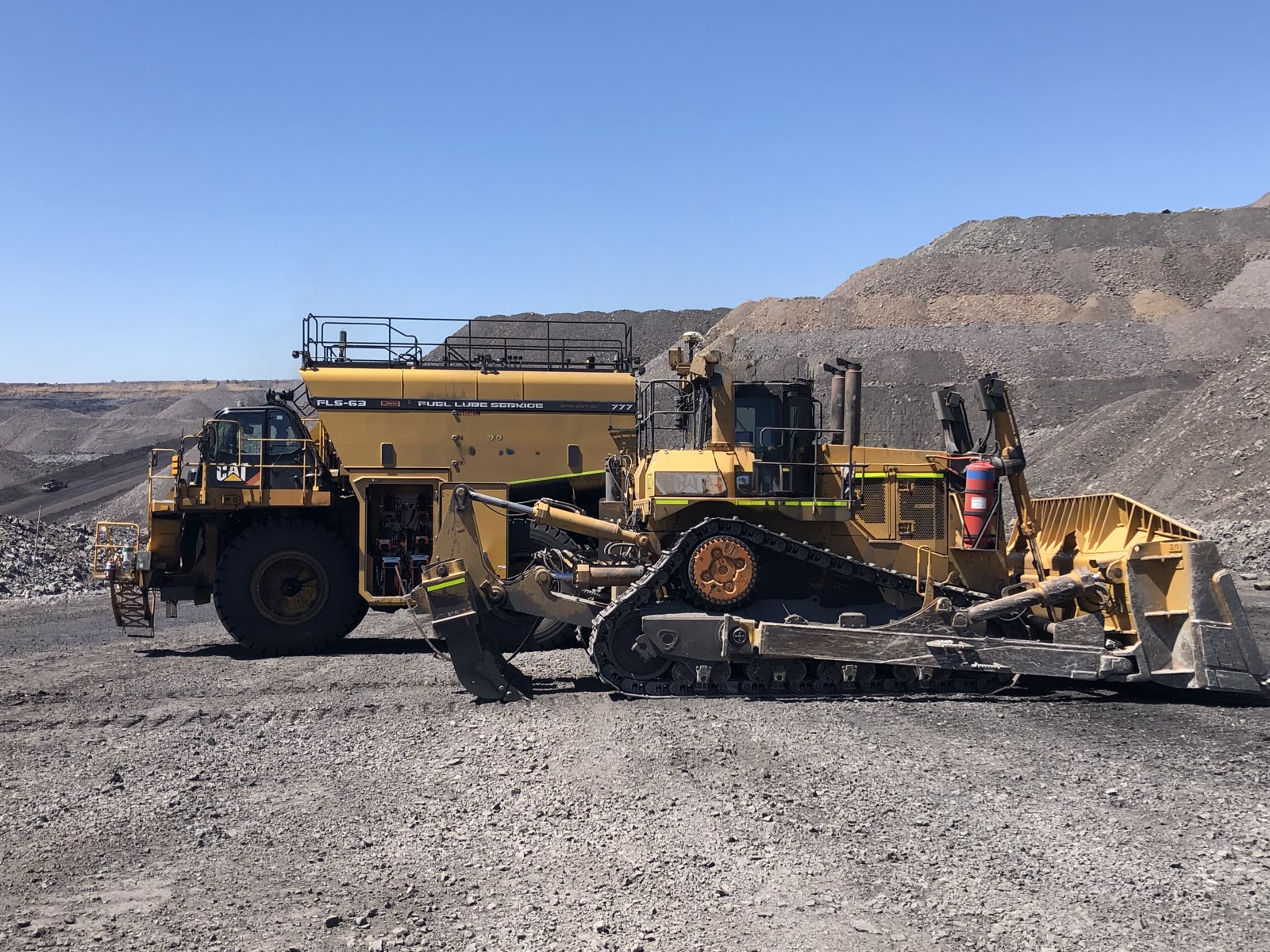 A QMW FLS-63 on a Cat 777 working beside a D11 dozer on a Central Queensland coal mine