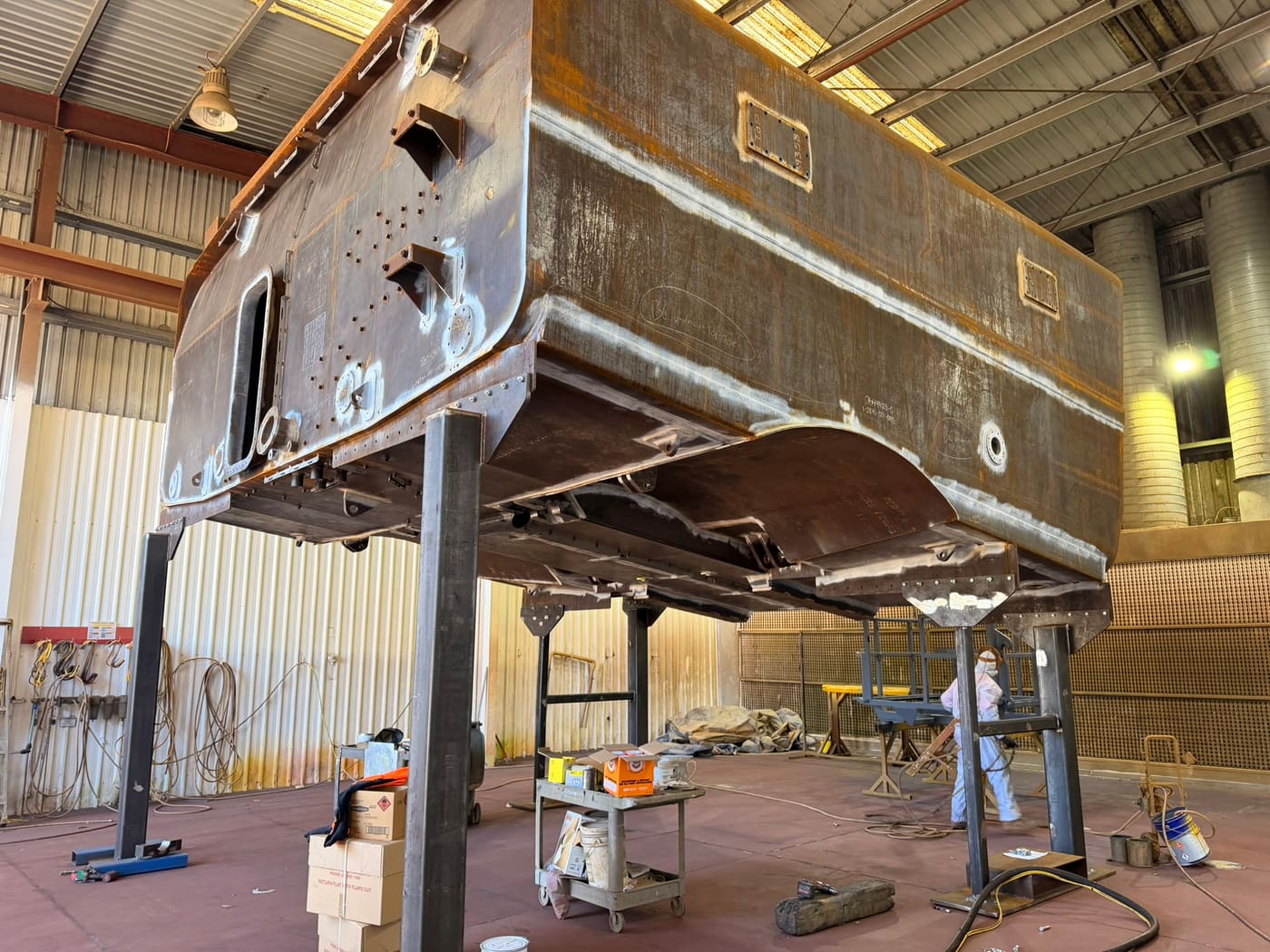 Haul truck body raised on stands after garnet blasting at QMW