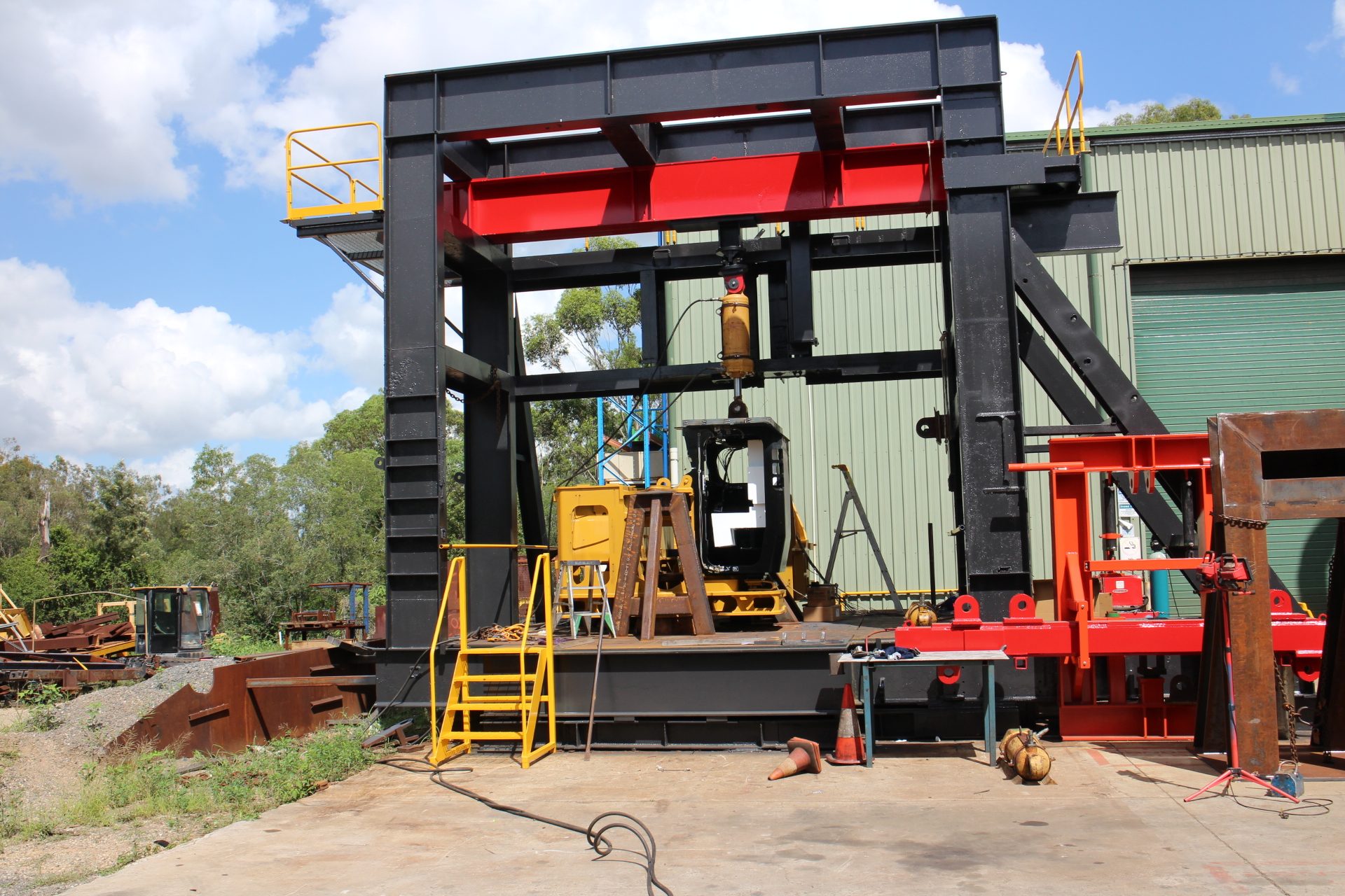 QMW destructive test rig loading a ROPS cabin